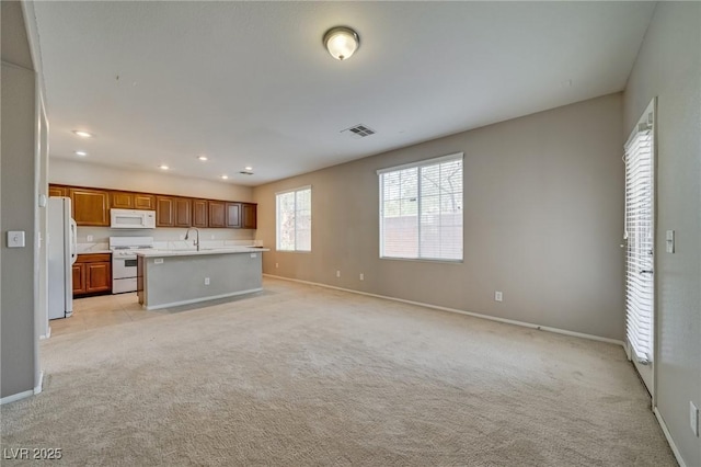 8348 Mokena Ave, Las Vegas, NV 89178 - unfurnished living room with a sink, baseboards, light colored carpet, and recessed lighting
