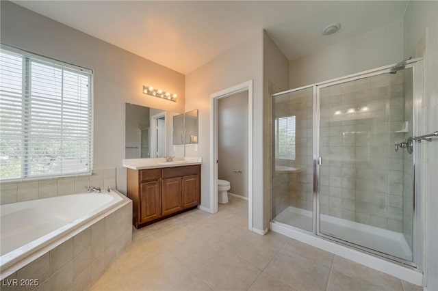 8348 Mokena Ave, Las Vegas, NV 89178 - bathroom featuring a shower stall, vanity, a bath, tile patterned floors, and toilet