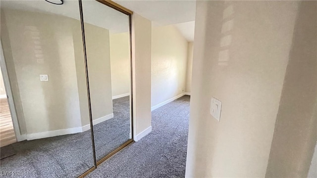 hallway with carpet and baseboards