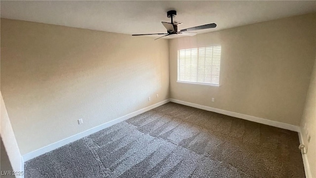 spare room with a ceiling fan, baseboards, and dark carpet