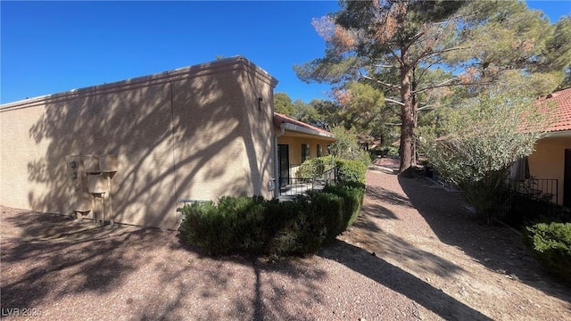 view of side of home featuring stucco siding