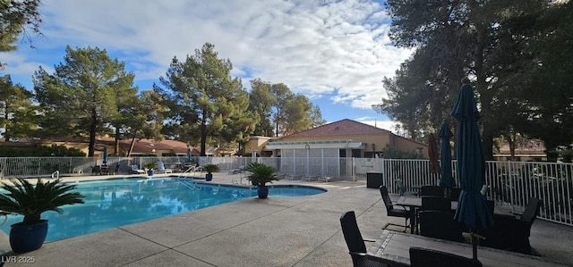 pool featuring a patio and fence