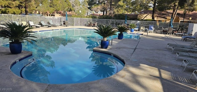 pool featuring a patio and fence