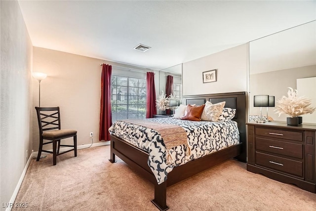 bedroom featuring visible vents, light carpet, and baseboards