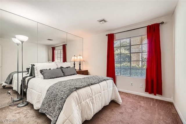 bedroom featuring visible vents, baseboards, and carpet