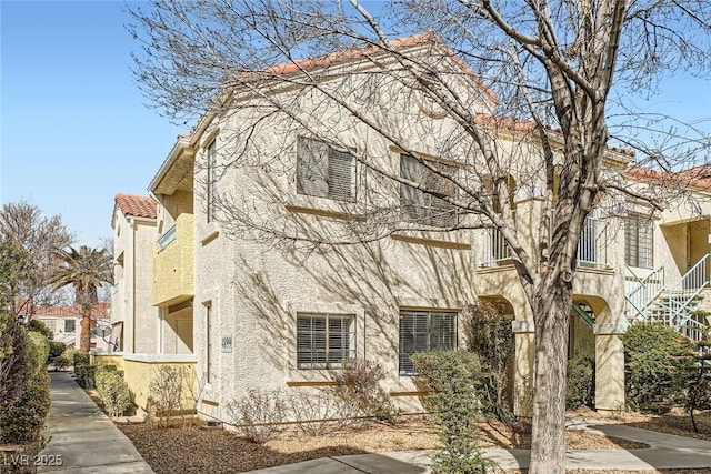 view of front of house featuring stucco siding and a tiled roof