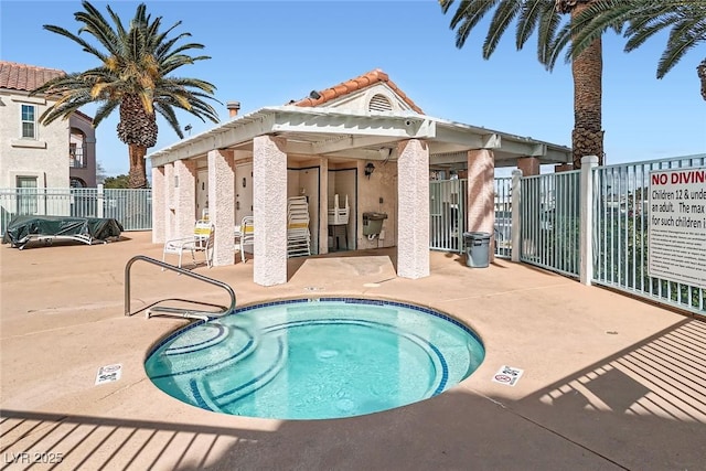 view of pool with a patio, a community hot tub, and fence