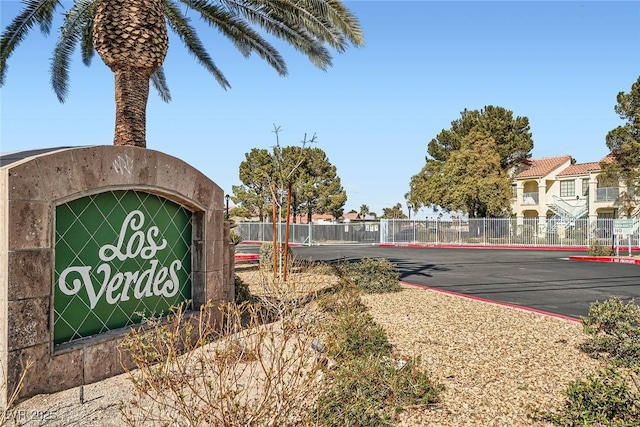 community / neighborhood sign with fence