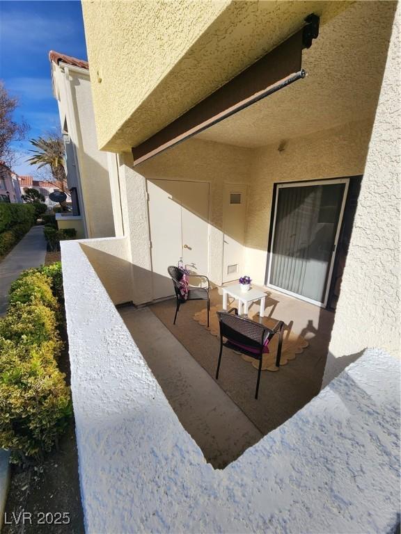 view of patio featuring a balcony