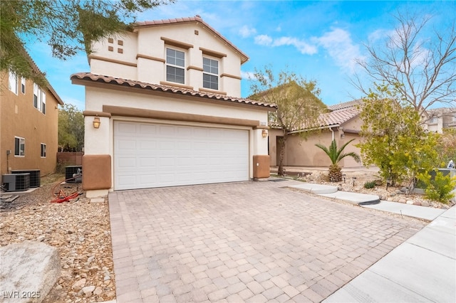 6177 W Cougar Ave, Las Vegas, NV 89139 - mediterranean / spanish home with stucco siding, central air condition unit, driveway, a tile roof, and a garage