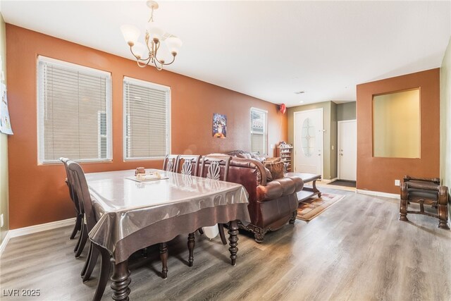 6177 W Cougar Ave, Las Vegas, NV 89139 - dining space featuring baseboards, a notable chandelier, and light wood-style flooring
