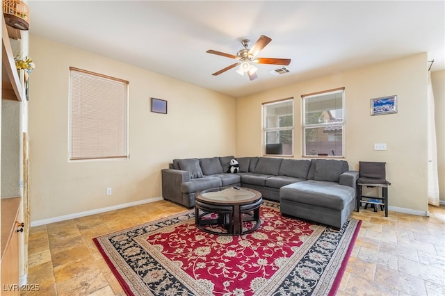 6177 W Cougar Ave, Las Vegas, NV 89139 - living room with stone tile floors, visible vents, baseboards, and ceiling fan