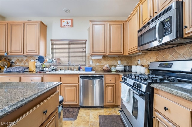 6177 W Cougar Ave, Las Vegas, NV 89139 - kitchen featuring tasteful backsplash, light brown cabinets, dark stone counters, appliances with stainless steel finishes, and a sink
