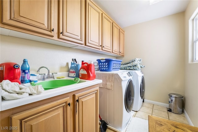 6177 W Cougar Ave, Las Vegas, NV 89139 - laundry area featuring washer and dryer, a sink, cabinet space, light tile patterned floors, and baseboards