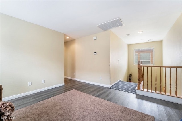 6177 W Cougar Ave, Las Vegas, NV 89139 - empty room with visible vents, baseboards, and dark wood-style floors