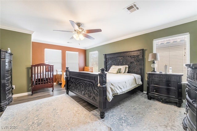 6177 W Cougar Ave, Las Vegas, NV 89139 - bedroom featuring wood finished floors, visible vents, baseboards, ceiling fan, and crown molding