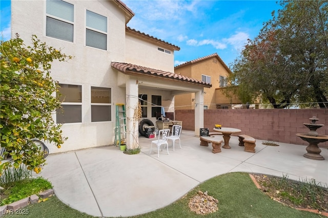 6177 W Cougar Ave, Las Vegas, NV 89139 - back of property with stucco siding, fence, a tile roof, and a patio area
