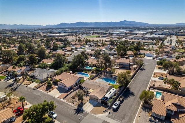 drone / aerial view featuring a residential view and a mountain view