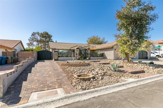 single story home with stucco siding, fence, and a gate