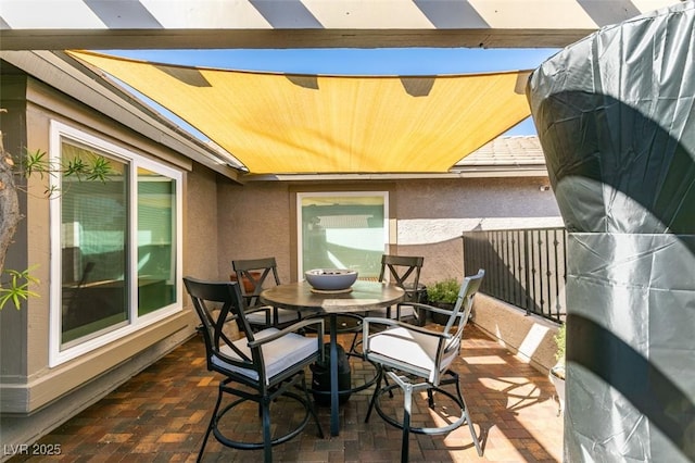 balcony with a patio and outdoor dining area