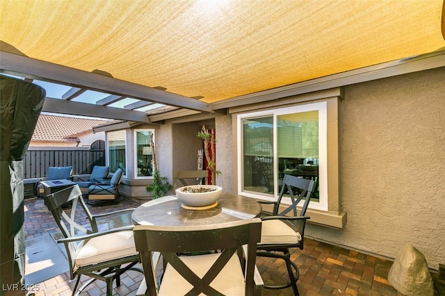 view of patio with fence, outdoor dining space, and a pergola