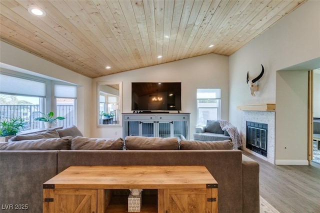 living room with a tiled fireplace, wood finished floors, recessed lighting, lofted ceiling, and wood ceiling