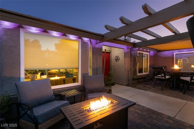 view of patio with an outdoor fire pit, outdoor dining area, and a pergola