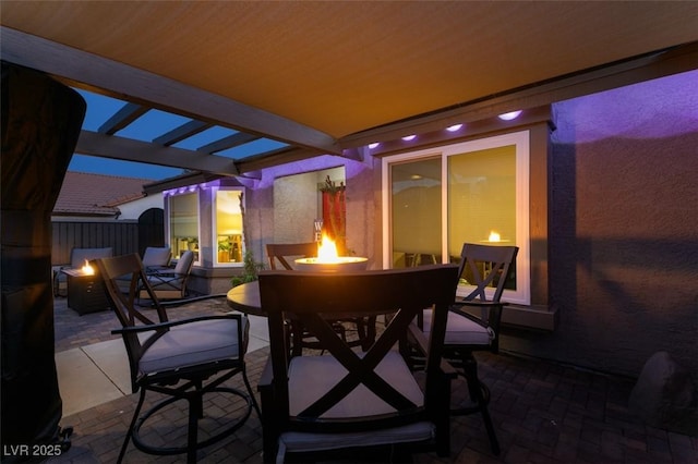 view of patio featuring outdoor dining area and a fire pit