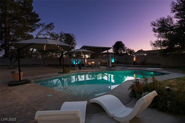 view of swimming pool featuring a patio area, a fenced in pool, and a fenced backyard