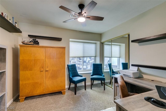 interior space featuring a ceiling fan and baseboards