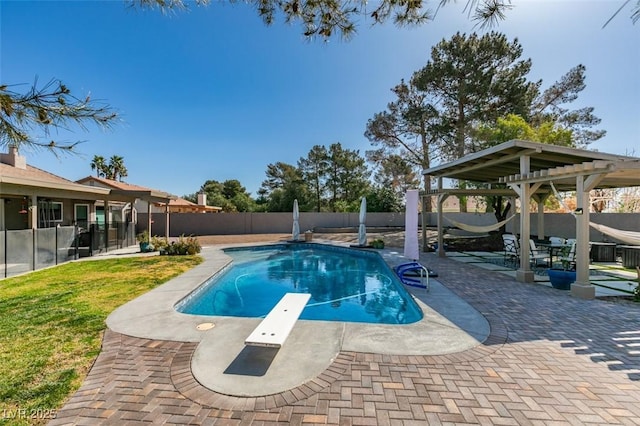 view of pool featuring a fenced in pool, a yard, a fenced backyard, a patio, and a diving board