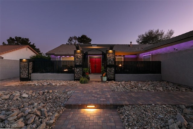 view of front of property with stone siding and stucco siding