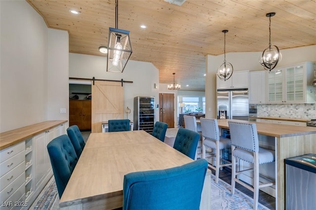 dining room featuring a barn door, recessed lighting, wood ceiling, and a chandelier