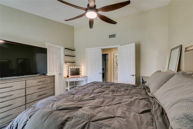 bedroom featuring visible vents, high vaulted ceiling, and ceiling fan