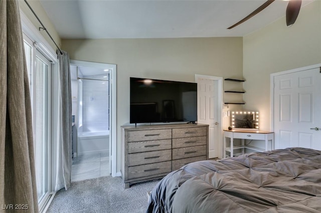 carpeted bedroom with ensuite bath, a ceiling fan, and vaulted ceiling