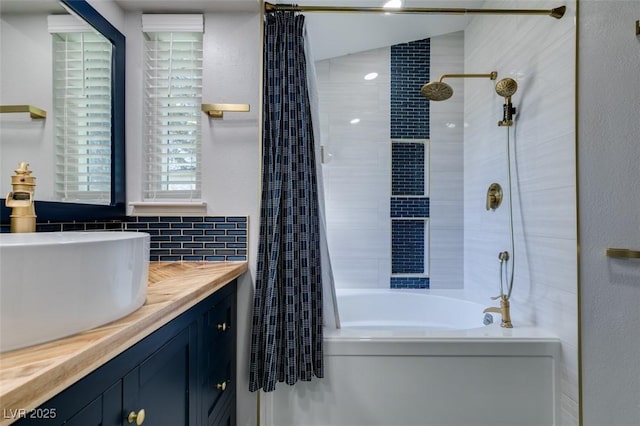 full bath with shower / bath combo with shower curtain, tasteful backsplash, and vanity