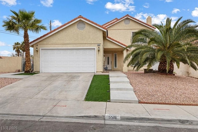 view of front of property with a tiled roof, stucco siding, driveway, and a garage