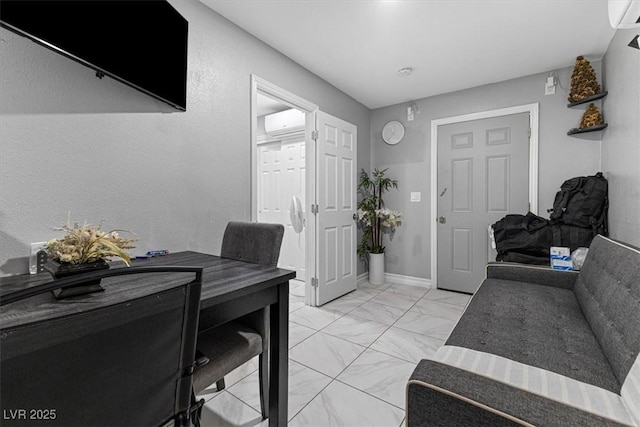 interior space with a wall mounted air conditioner, baseboards, and marble finish floor