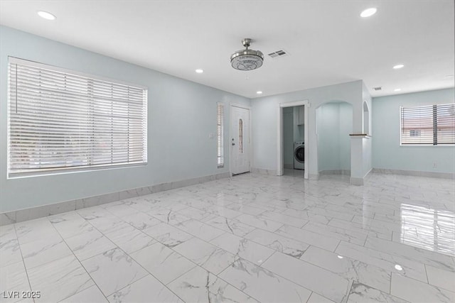 unfurnished room with visible vents, marble finish floor, recessed lighting, baseboards, and washer / dryer