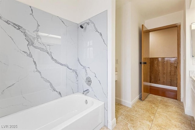 bathroom with baseboards and  shower combination