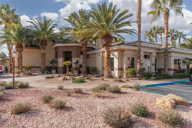 view of front of property featuring stucco siding and a tiled roof