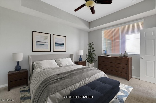 bedroom featuring light colored carpet, baseboards, and ceiling fan