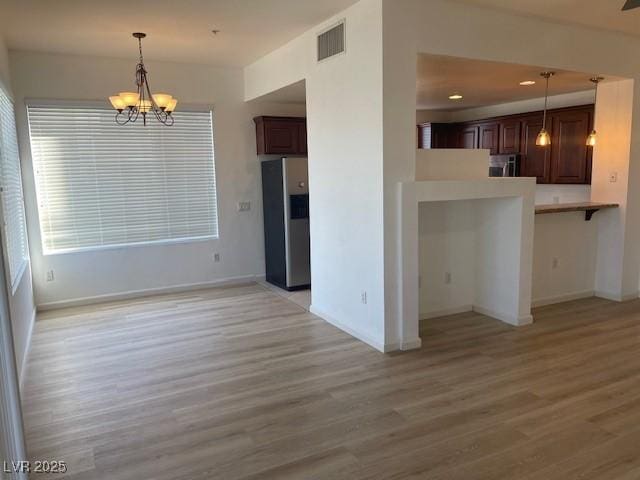 interior space featuring a notable chandelier, recessed lighting, visible vents, and light wood finished floors