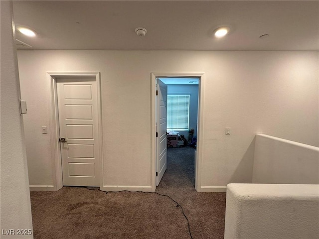 hall with carpet and baseboards