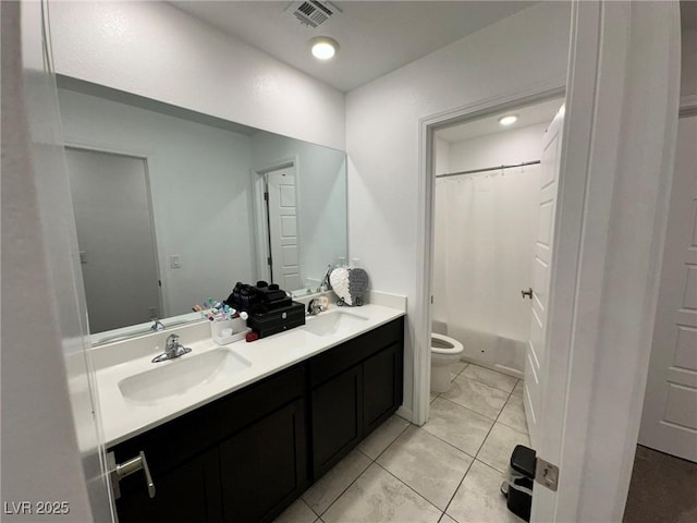 full bathroom featuring double vanity, toilet, visible vents, and a sink