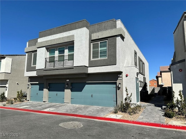 townhome / multi-family property featuring stucco siding and an attached garage