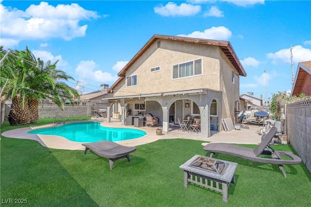 back of property with stucco siding, a fenced backyard, a fire pit, a fenced in pool, and a patio area