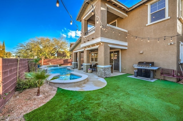 back of property with stucco siding, a fenced backyard, a yard, a balcony, and a patio