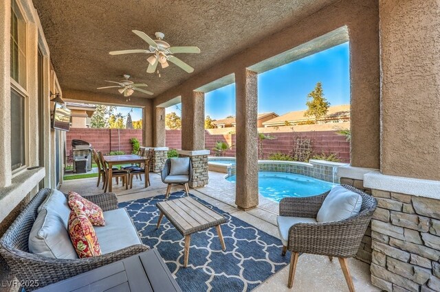 view of patio / terrace with a ceiling fan, outdoor dining space, a fenced backyard, and a fenced in pool