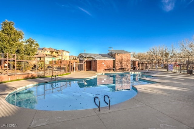 community pool with a patio and fence